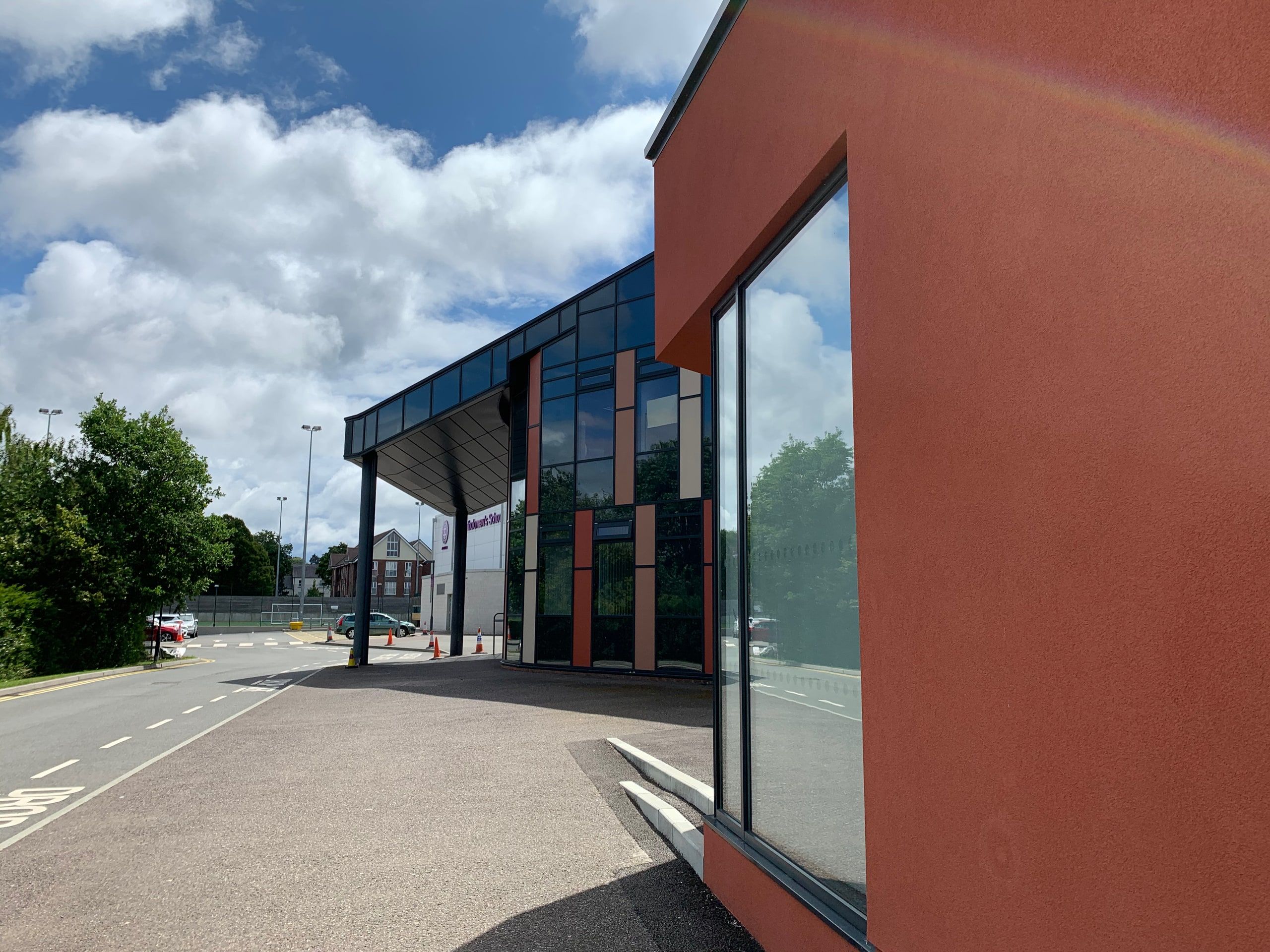 Rendered corner and glazed entrance canopy seen from the approach road, St Bartholomew's School, Newbury.