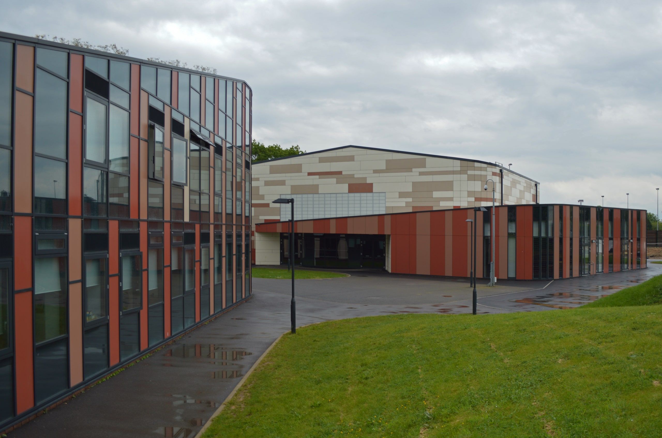 The extension's curved photovoltaic elevation running to the sports hall, St Bartholomew's School, Newbury.