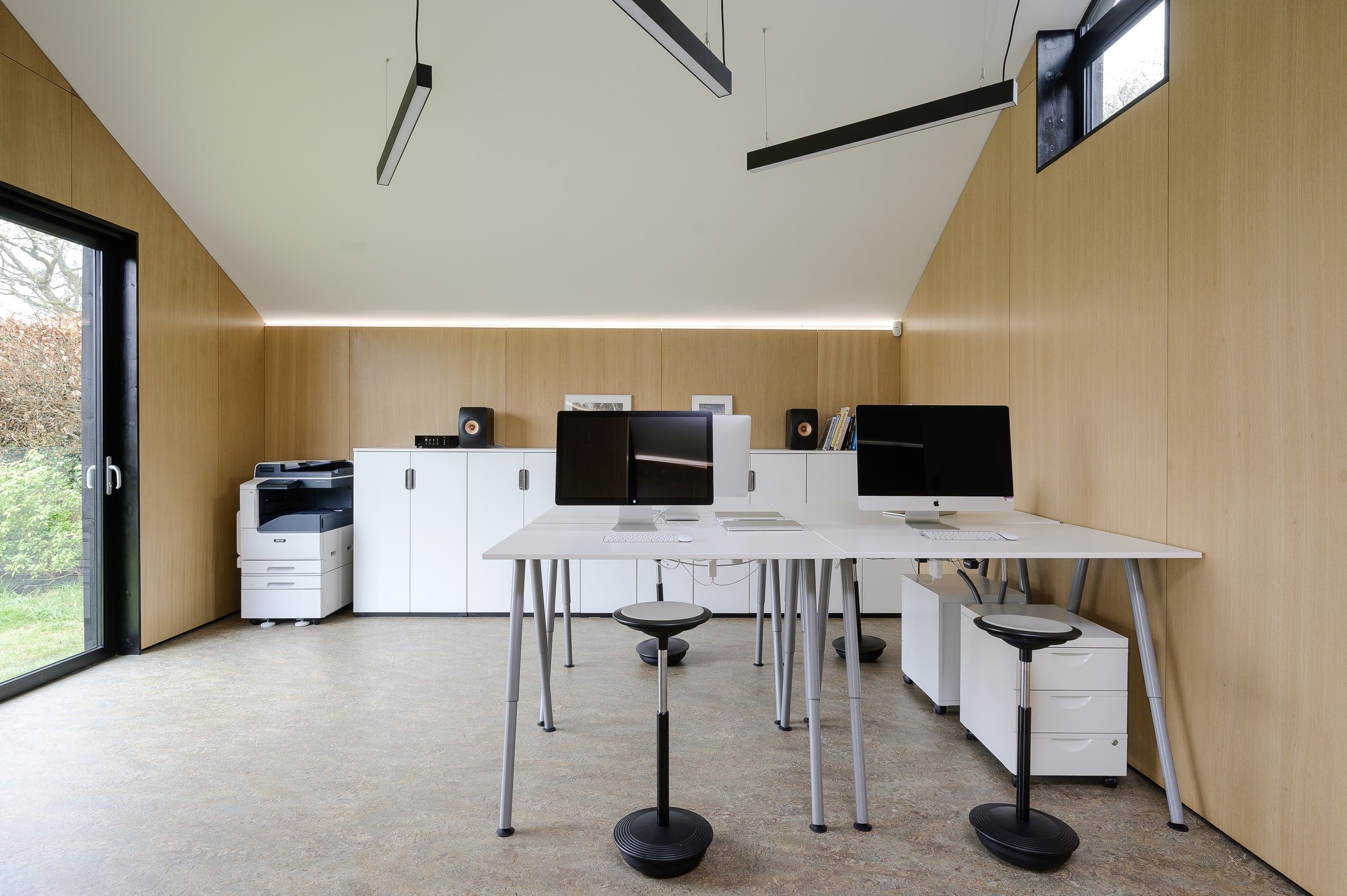 Desks under the vaulted oak-lined ceiling of the architects' studio, 1960s house, Fernhurst.