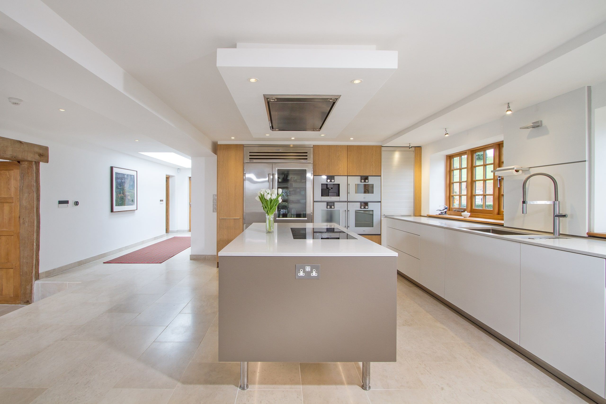 Kitchen looking the length of the room towards the hallway beyond, listed country house, Chiddingfold.